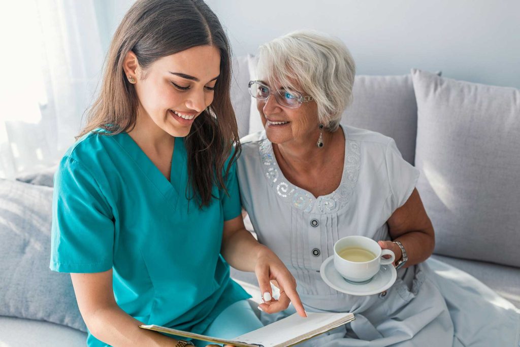 Caregiver helping elderly woman