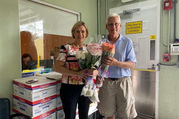 Jill Ball, president of VIP, with Rod McAlprin, a Meals on Wheels volunteer, taking donated roses to deliver to the Kane Center’s Senior Dining Centers in Jensen, East Stuart, Port Salerno and Indiantown.