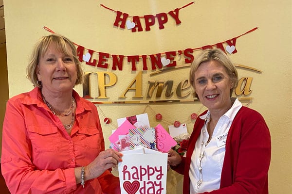 Jill Ball, right, president with VIP, receives 130 cards from Laura Eichholz made by a group of women at the Oceana Condominiums.